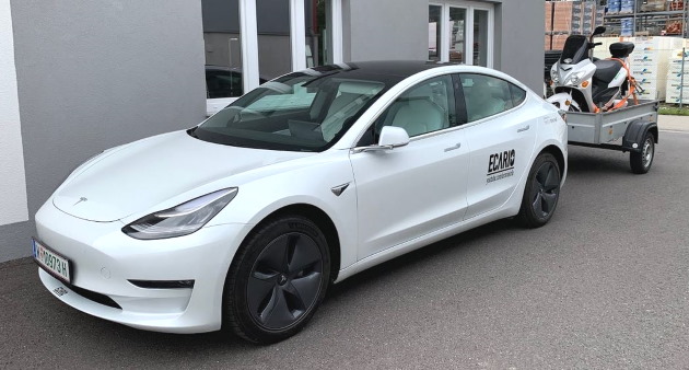 Tesla model 3 mit anhänger und e-scooter